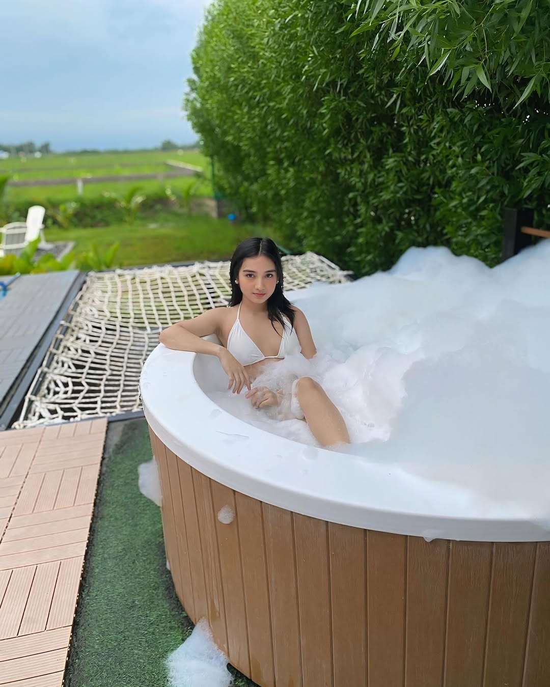 Wood barrel heated jacuzzi at Kalinaya — lush bamboo backdrop